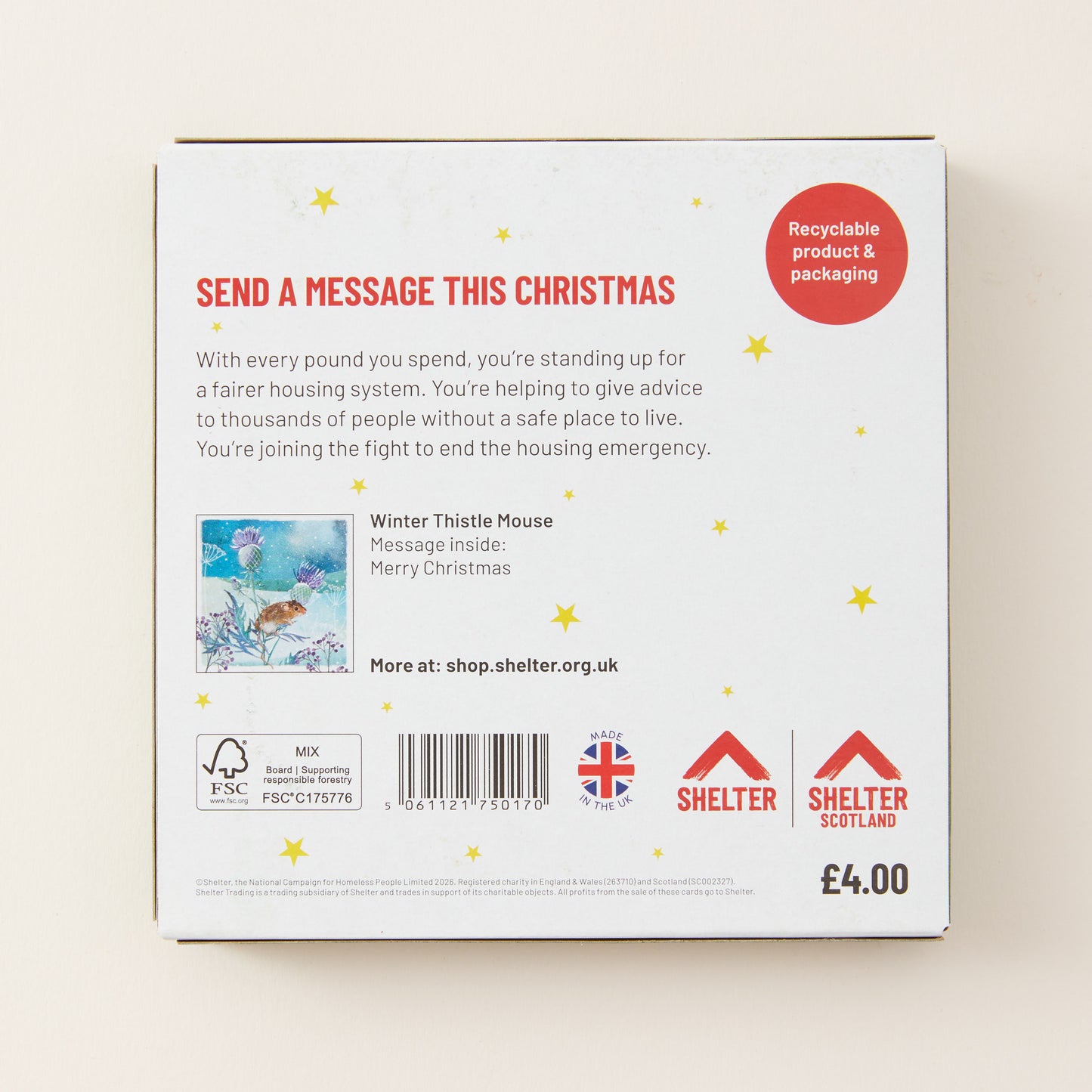 The back of a white cardboard message box for Shelter Christmas, featuring red and black text, a small message illustration, and Shelter branding on a light beige background.