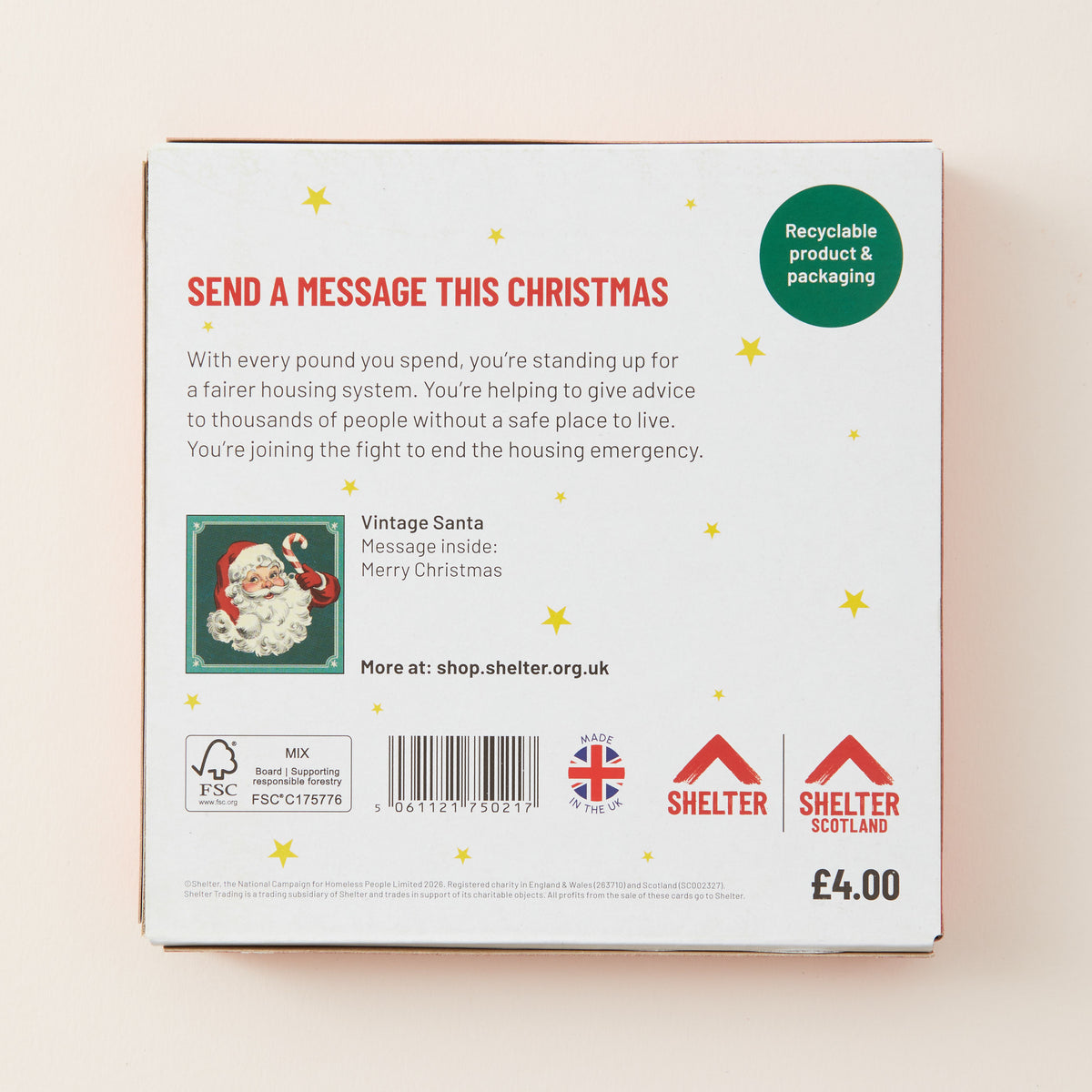 The back of a white Christmas message card envelope or packaging box, featuring red and green text, a small Santa illustration, recycling and FSC logos, a barcode, and Shelter branding.