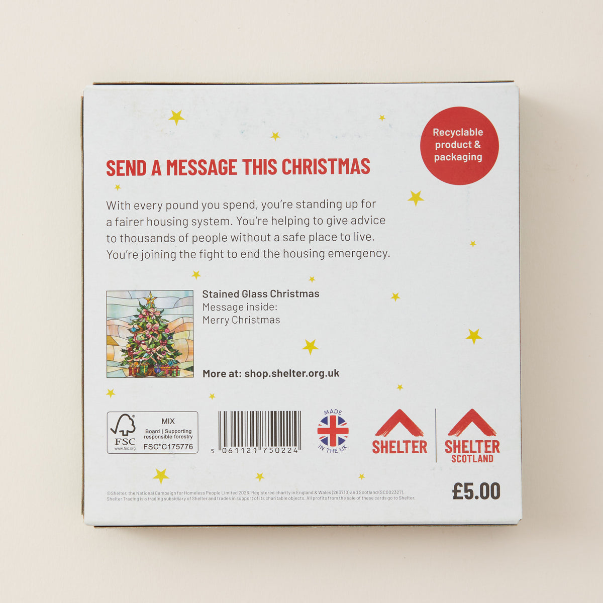 The back of a white product box for a 'Stained Glass Christmas' message kit, featuring red and black text, gold star illustrations, a small stained glass illustration, and Shelter Scotland branding.