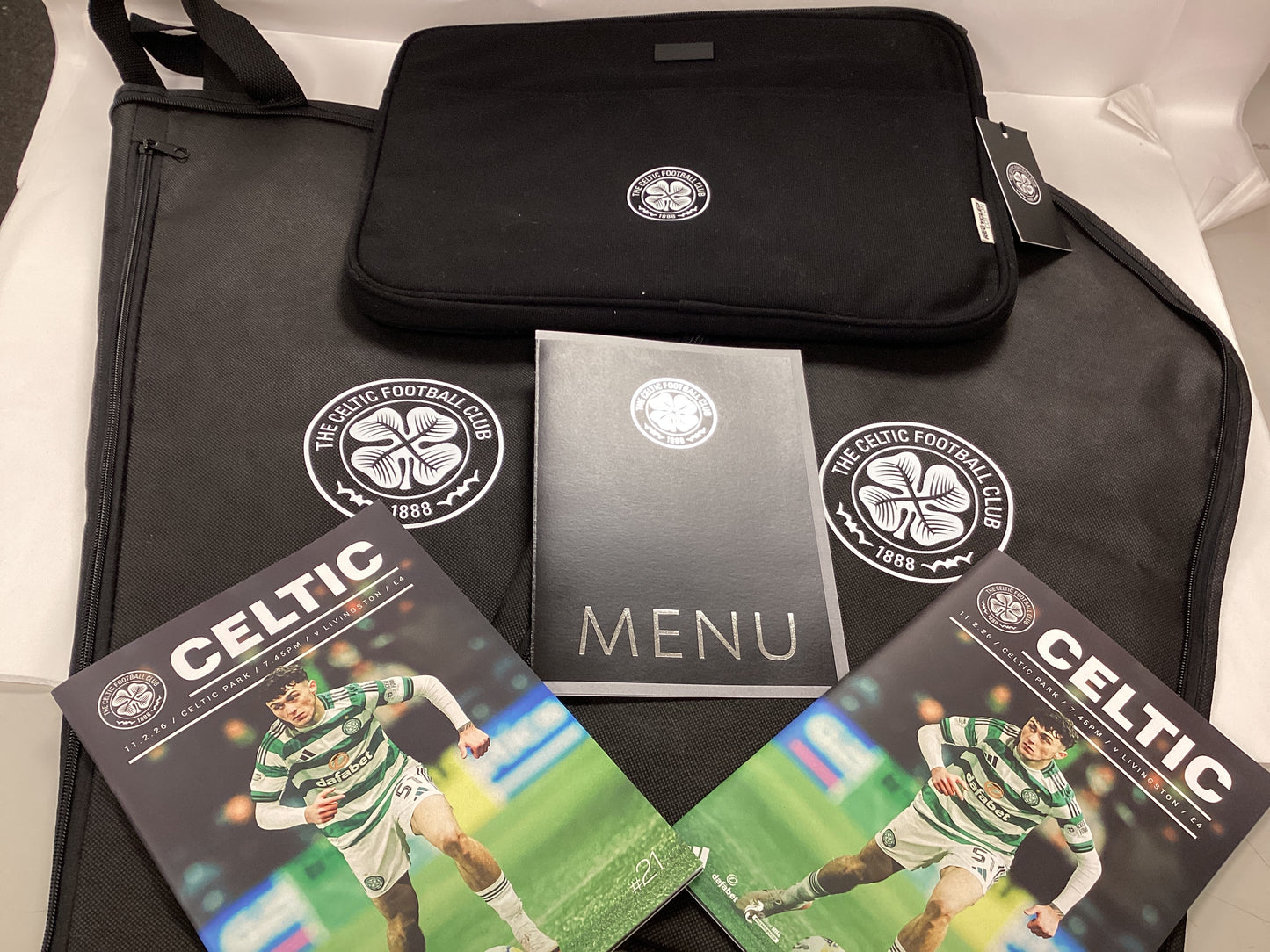 Celtic Hospitality Gifts from Celtic FC vs Livingston FC Match 11/02/2026. 2x Programmes, 2x Suit Carriers, 1x Laptop Bag, 1x Menu