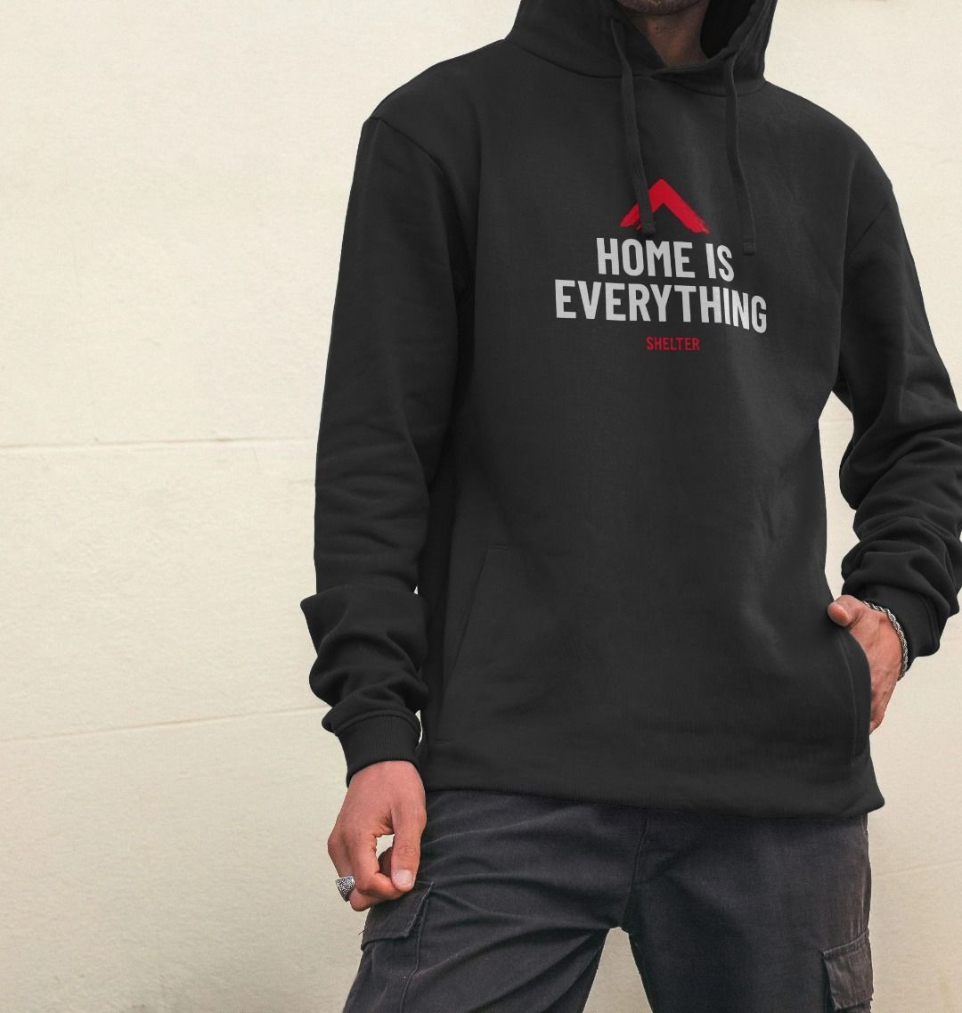Black hoodie with 'Home is Everything' design being modelled with the hood up. 
