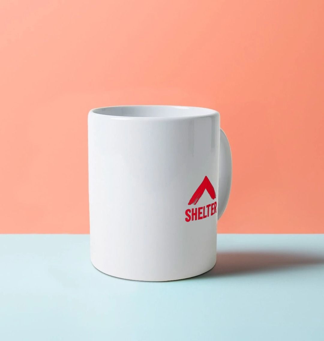 White mug with the Shelter logo