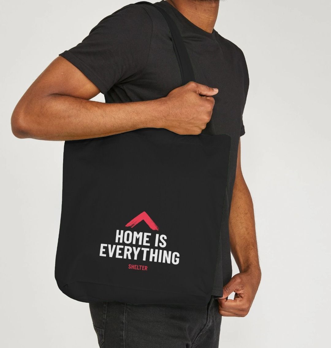 Man with the 'Home is Everything' tote bag on his shoulder