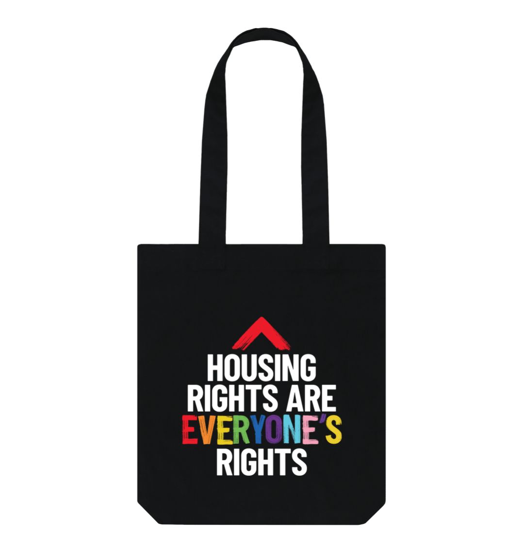 black tote bag with slogan "Housing rights are everyone's rights" The word everyone's is in the LGBTQ+ flag colours