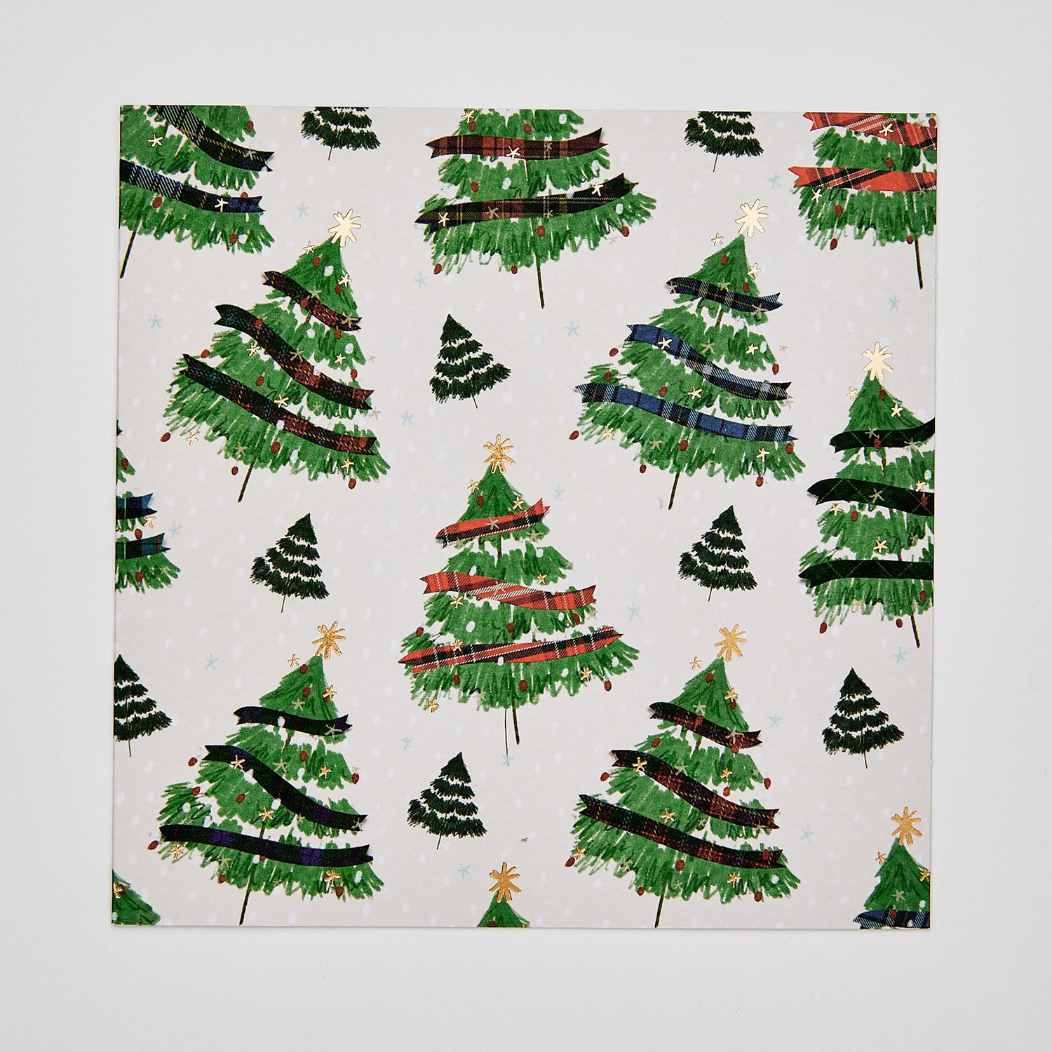 Flat lay of christmas card depicting christmas trees with tartan decorations