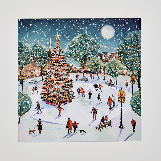 Flat lay christmas card which depicts people skating in a park ice rink