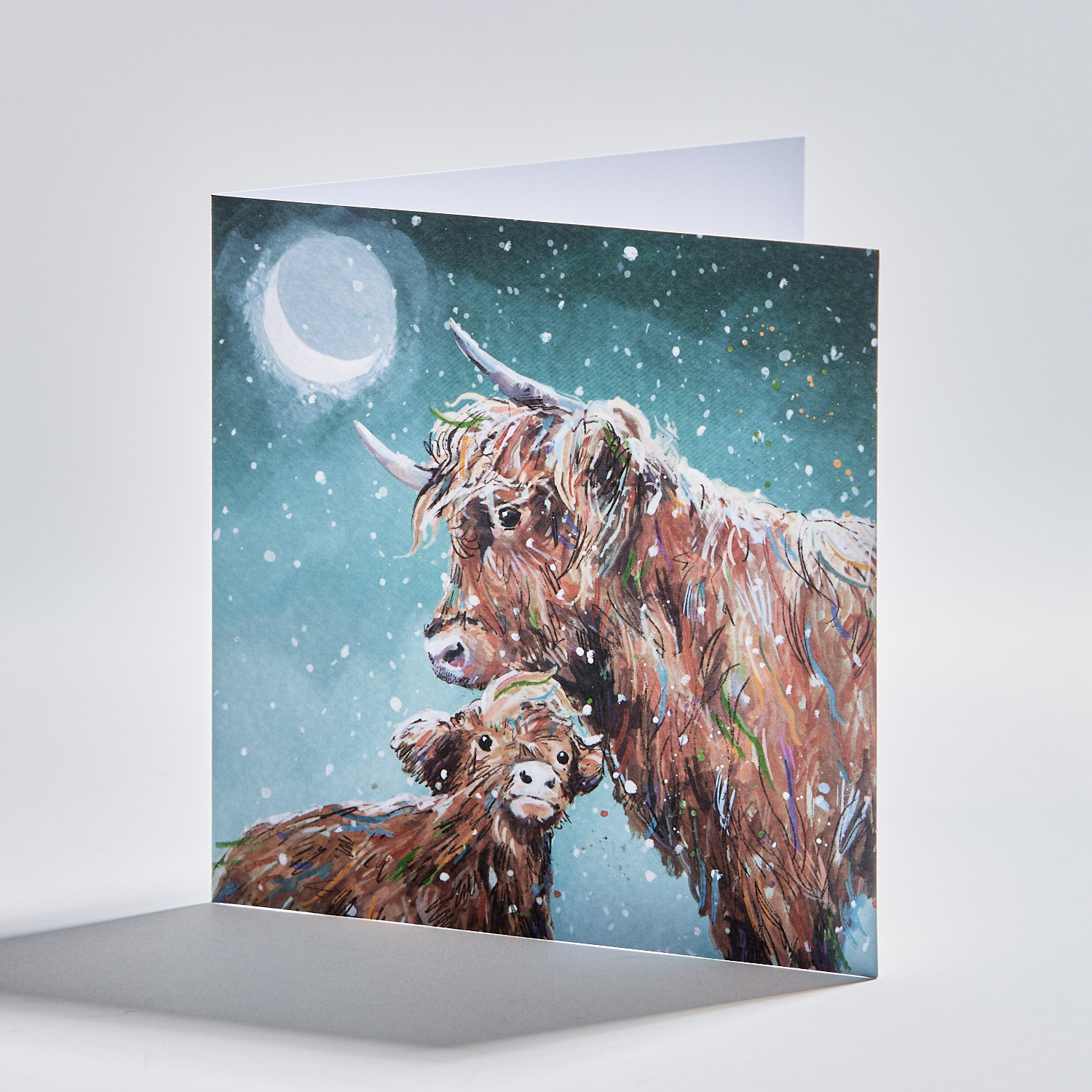 standing christmas card depicting highland cows under a snowy moonlit night