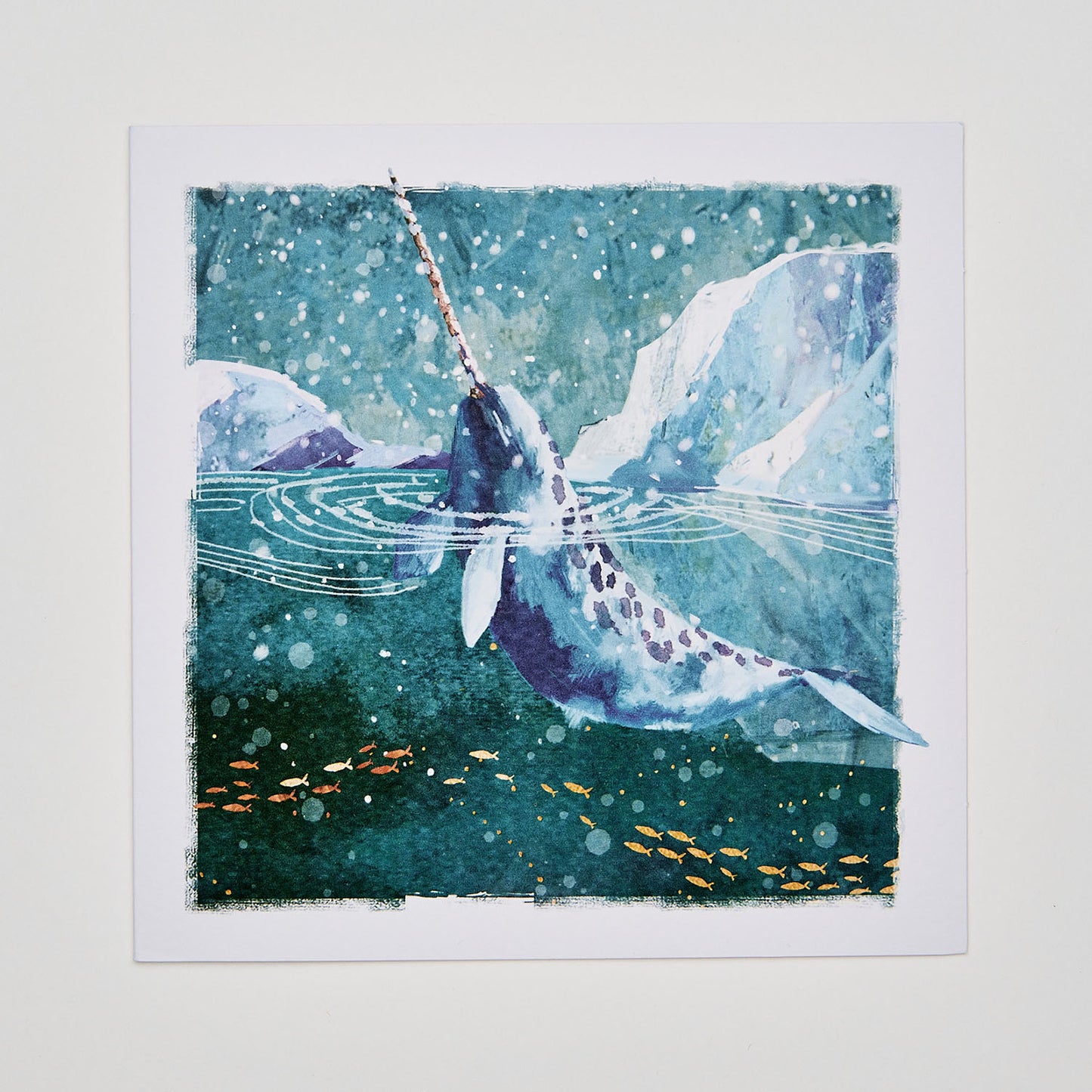 Flat lay christmas card depicting a narwhal in arctic waters