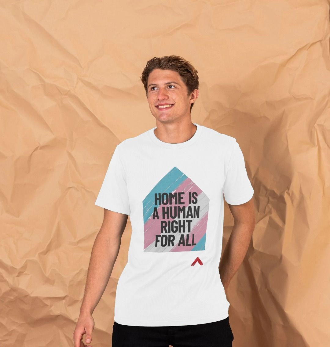 Home is a Human Right for All white T-shirt, t-shirt design is a house shape filled with trans flag colours with black bold slogan "Home is human right for all"