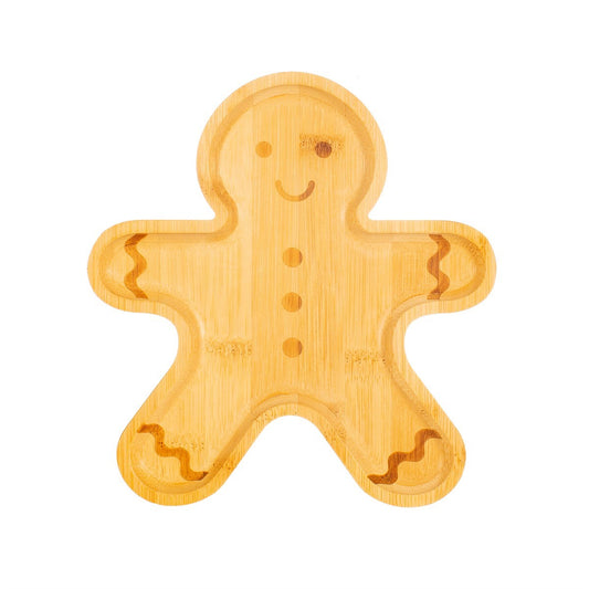 Bamboo plate in the shape of a gingerbread man darker wood for his face buttons and hands/ feet.