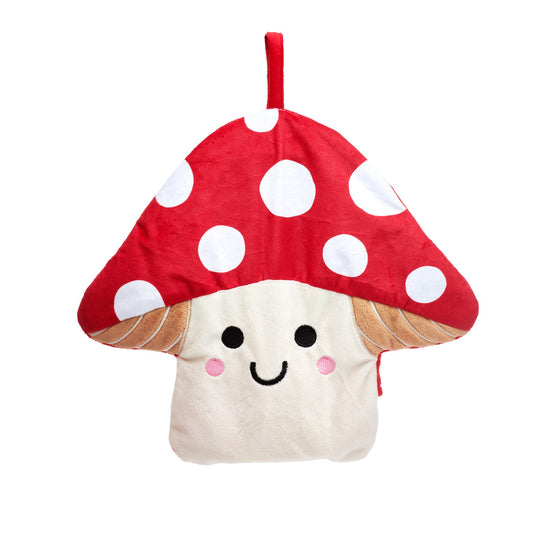 A red and white toadstool mushroom hot water bottle with a smiling face and a red hook for hanging, sitting against a white background.