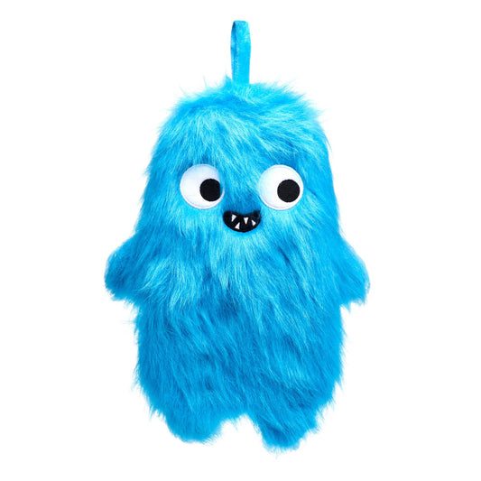 A blue fluffy hot water bottle, shaped like a monster with small round hands and feet. The monster has big eyes looking to the right, and a small smile with four sharp teeth showing. The monster hot water bottle sits against a white background.