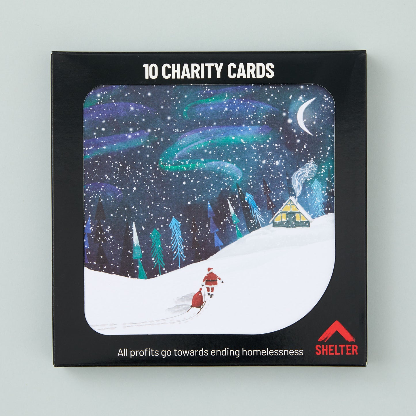 Pack of 10 'North Pole Night' Christmas cards in a black Shelter branded card box. 