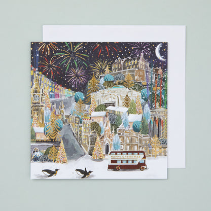 A square Christmas card with an illustration of a festive Edinburgh, with fireworks in the sky.