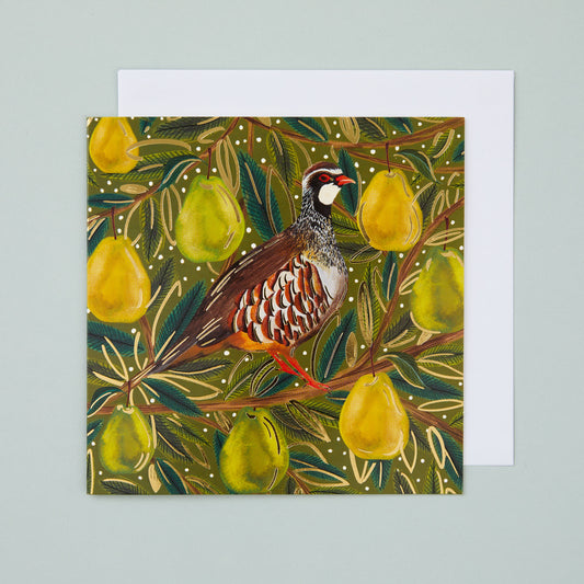 A square Christmas card with a gold foiled design of a partridge sitting in a pear tree.