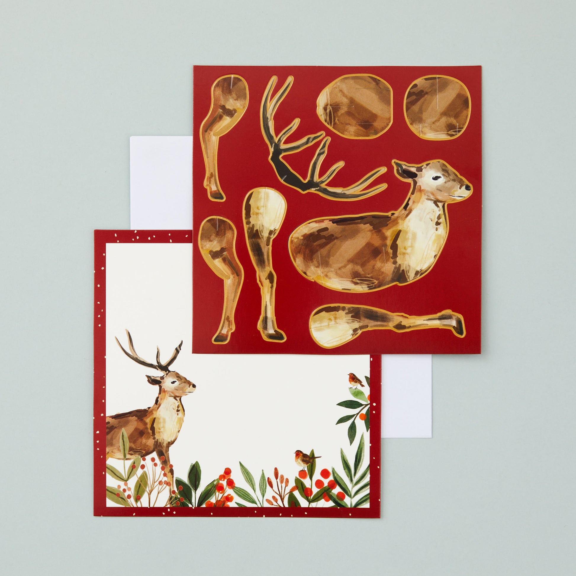 Two flat square cards, one with a space on for your own message and the other with the pieces that make up the stag, which can be popped out of the card to assemble.