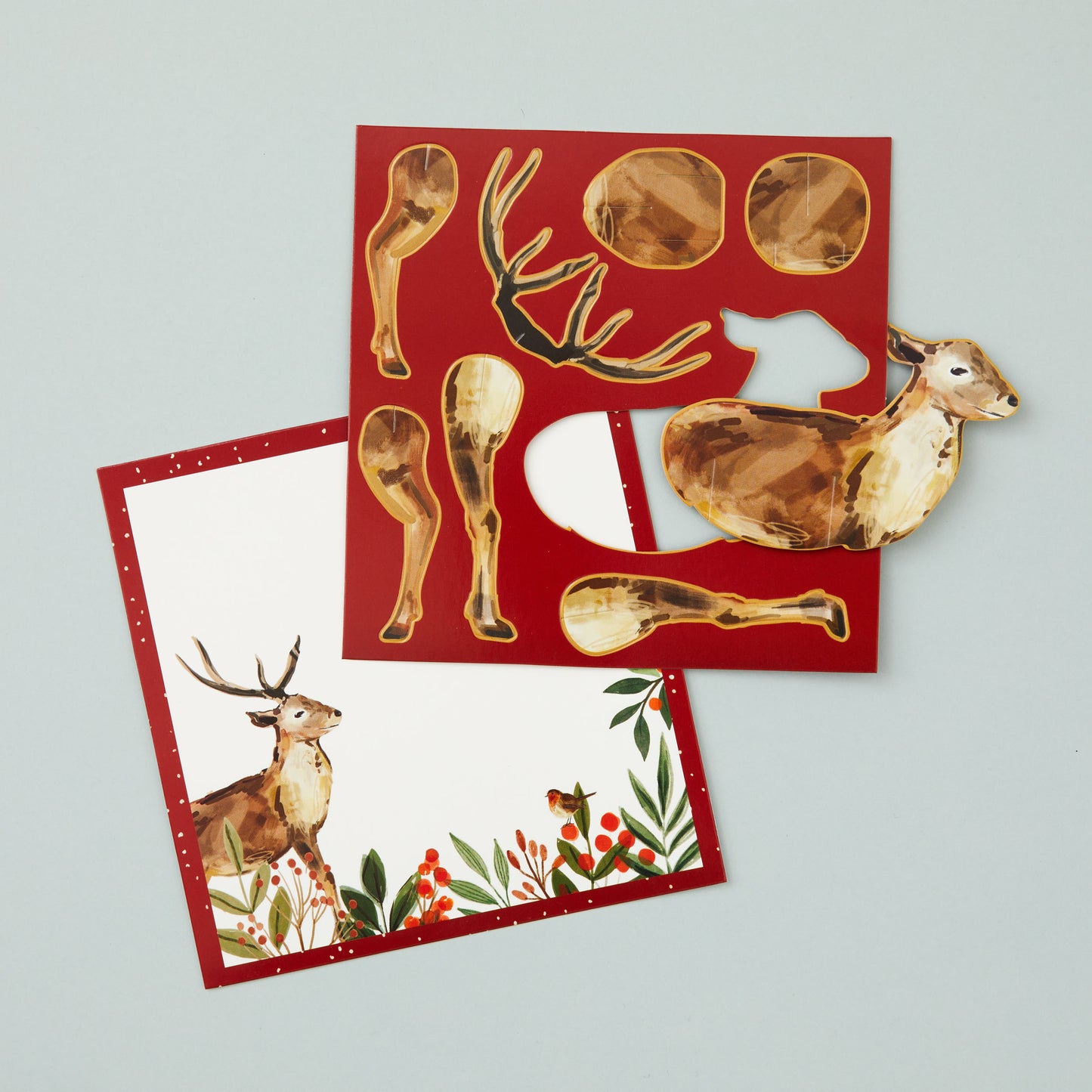 Two flat square cards, one with a space on for your own message and the other with the pieces that make up the stag, which can be popped out of the card to assemble.