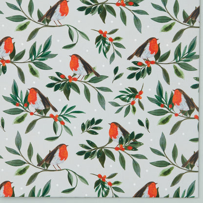 Close up of 'Berry Bough' design - red robins perched on a bough of festive foliage.