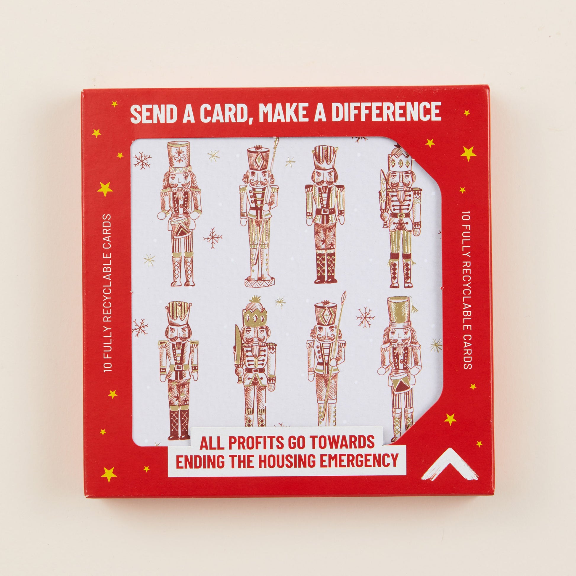 A Christmas card with eight nutcrackers on the front, the card shown in red cardboard packaging with the title: 'Send a card, make a difference'