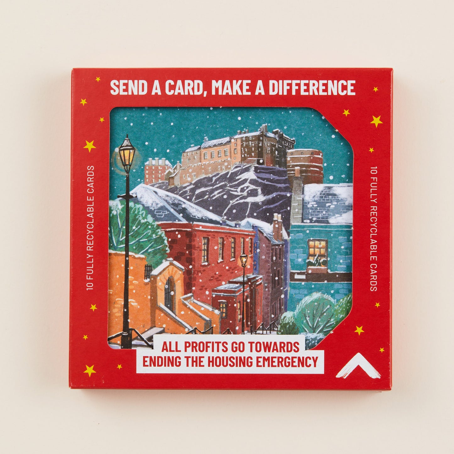 A Christmas card depicting a snowy town underneath Edinburgh Castle, the card shown in red cardboard packaging with the title: 'Send a card, make a difference'