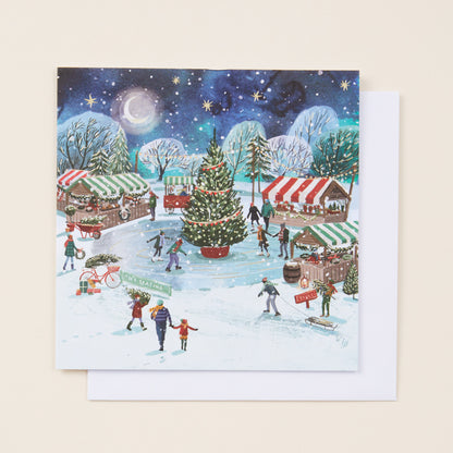 Christmas card with winter scene, trees, and people skating on ice.