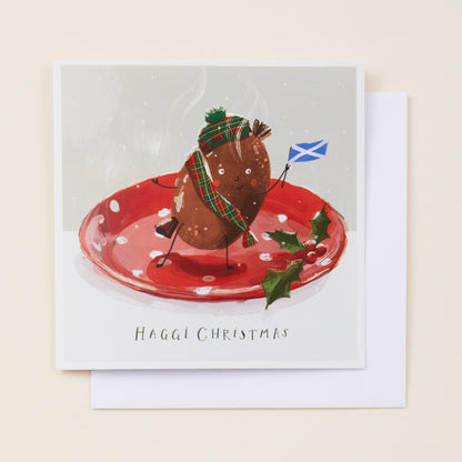 Christmas card with a haggis on a plate, wearing a hat and scarf, with a Scottish flag, on a beige background. Copy reads 'haggi christmas'