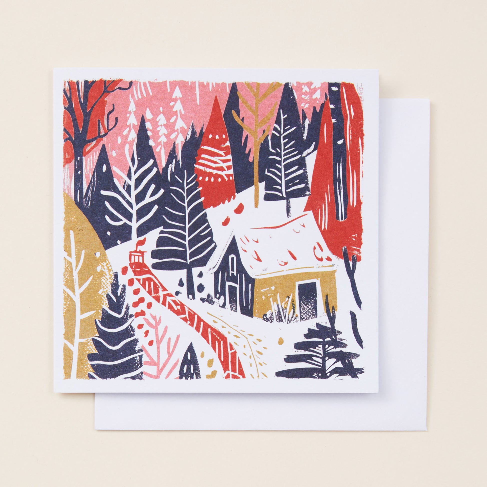 Christmas card with a winter forest design featuring trees and a cabin on a beige background.