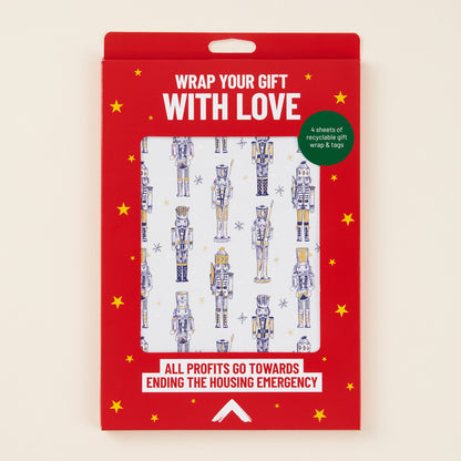 Red packaging with nutcracker design wrapping paper and tags inside. 