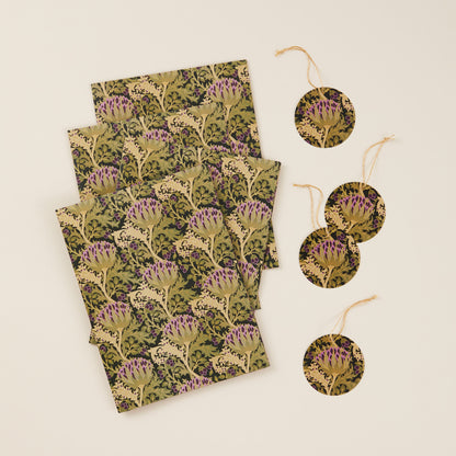 Four sheets of vintage thistle patterned gift wrap alongside four matching gift tags with gold string.