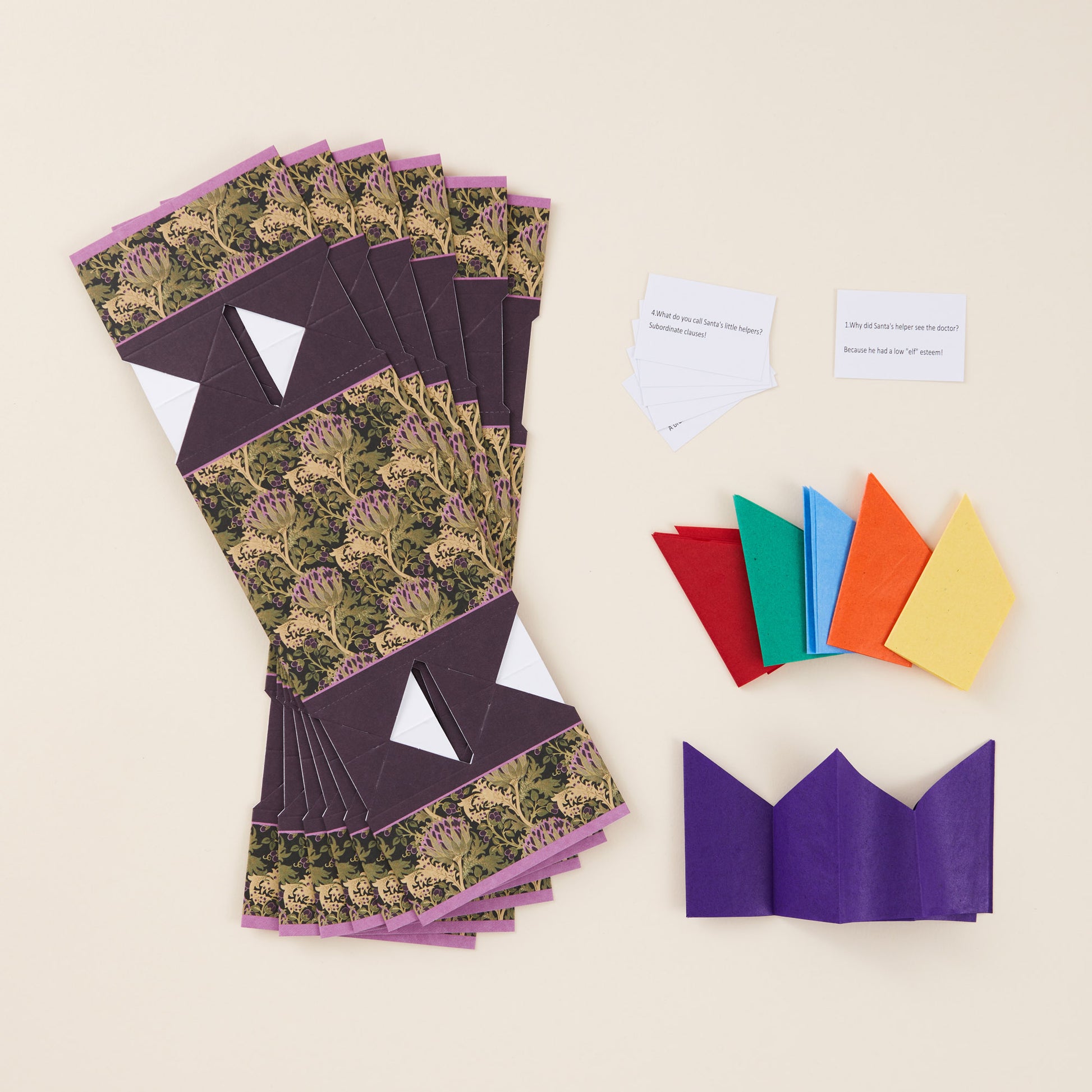 Flat pack Christmas crackers, shown alongside coloured paper hats and jokes