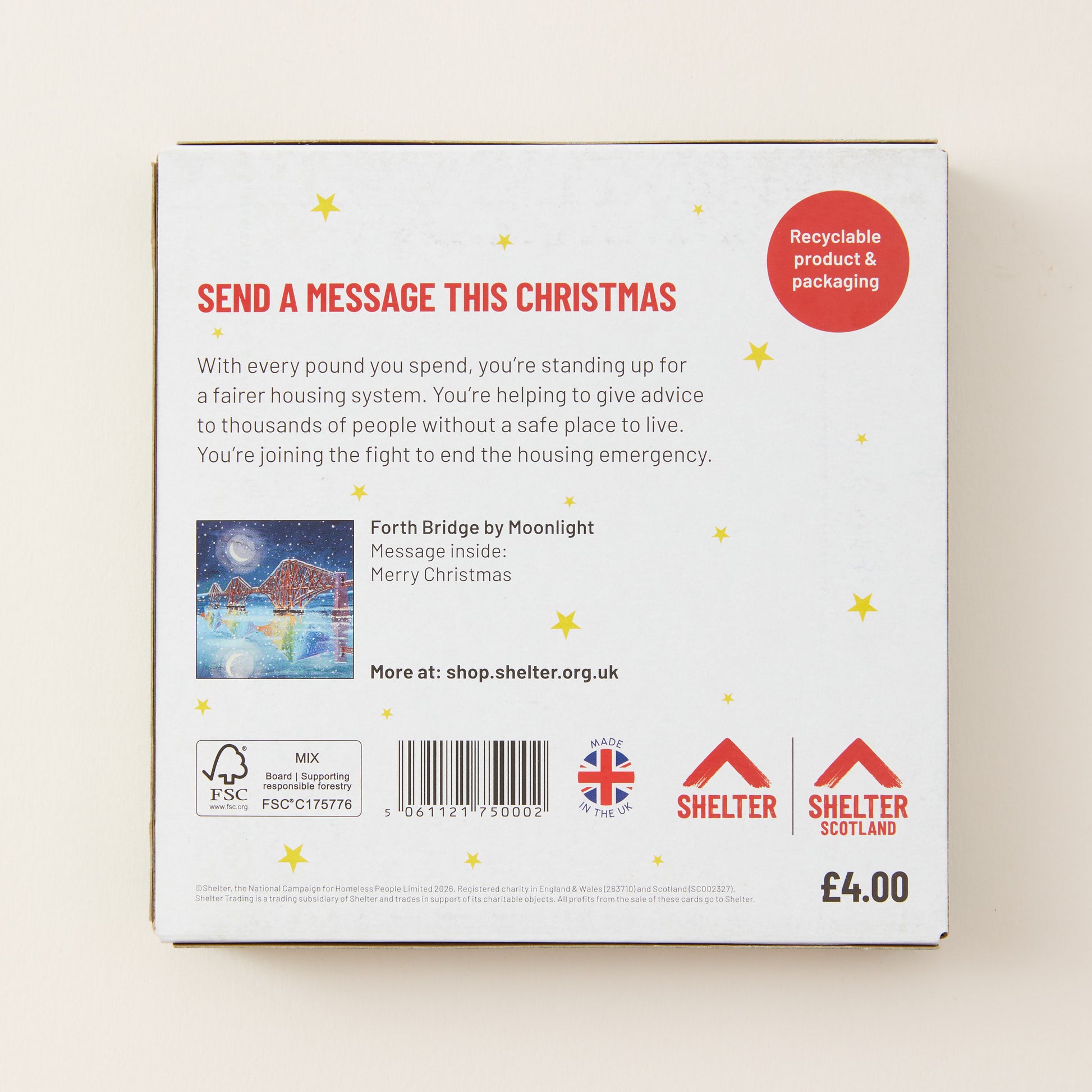 The back of a white rectangular product box for Shelter Christmas message cards, featuring red and black text, a small Christmas illustration, and Shelter branding on a light beige background.
