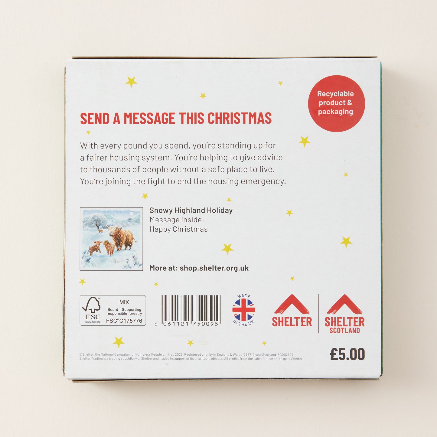 The back of a white cardboard message box for Shelter, featuring red and black text, a barcode, a small holiday photo, and recycling and certification logos on a light beige background.