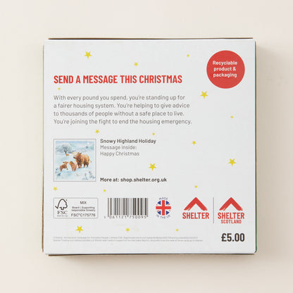 The back of a white cardboard message box for Shelter, featuring red and black text, a barcode, a small holiday photo, and recycling and certification logos on a light beige background.