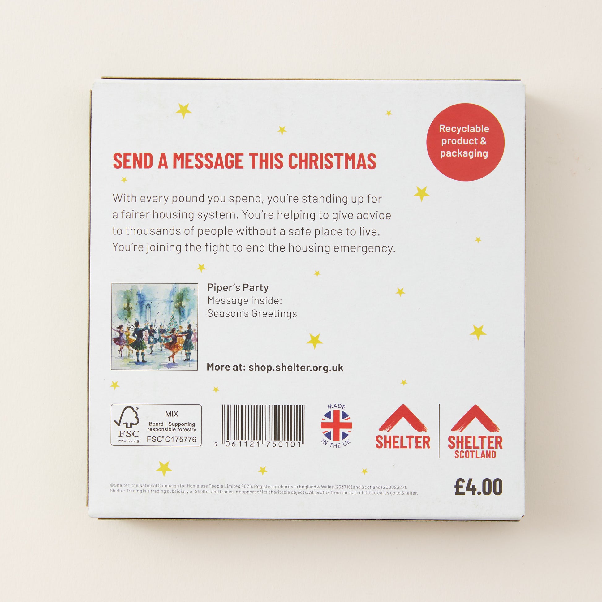 The back of a white cardboard box for a Christmas message service, featuring red and black text, a small illustration, and logos for Shelter and Birkwood Trust. The box is photographed on a light beige background.