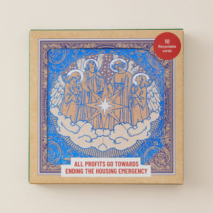 A square product box for a card deck featuring an illustrated angel scene in blue and gold with white clouds and a central star. The box has a red circular sticker reading '10 Recyclable cards' and a white banner at the bottom that says 'ALL PROFITS GO TOWARDS ENDING THE HOUSING EMERGENCY.