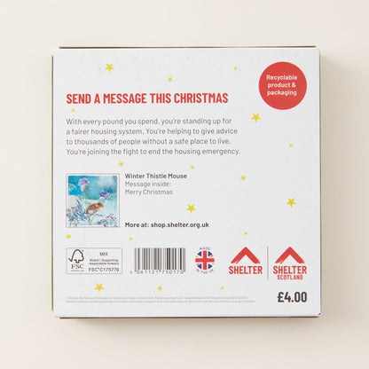 The back of a white cardboard message box for Shelter Christmas, featuring red and black text, a small message illustration, and Shelter branding on a light beige background.