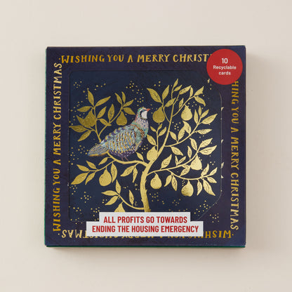 A square Christmas card set box with a navy blue background and gold foil illustration of a bird perched on a leafy tree. The box includes gold text reading 'Wishing you a merry Christmas' and a red circular badge that says '10 recyclable cards.