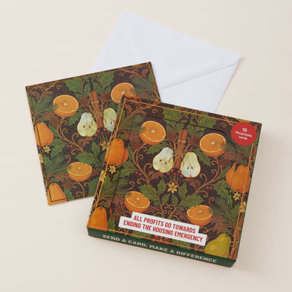 A square greeting card and matching envelope displayed on a light beige background. The card features an ornate vintage-style botanical illustration with oranges, pears, cinnamon sticks, and floral motifs on a dark green and brown background.