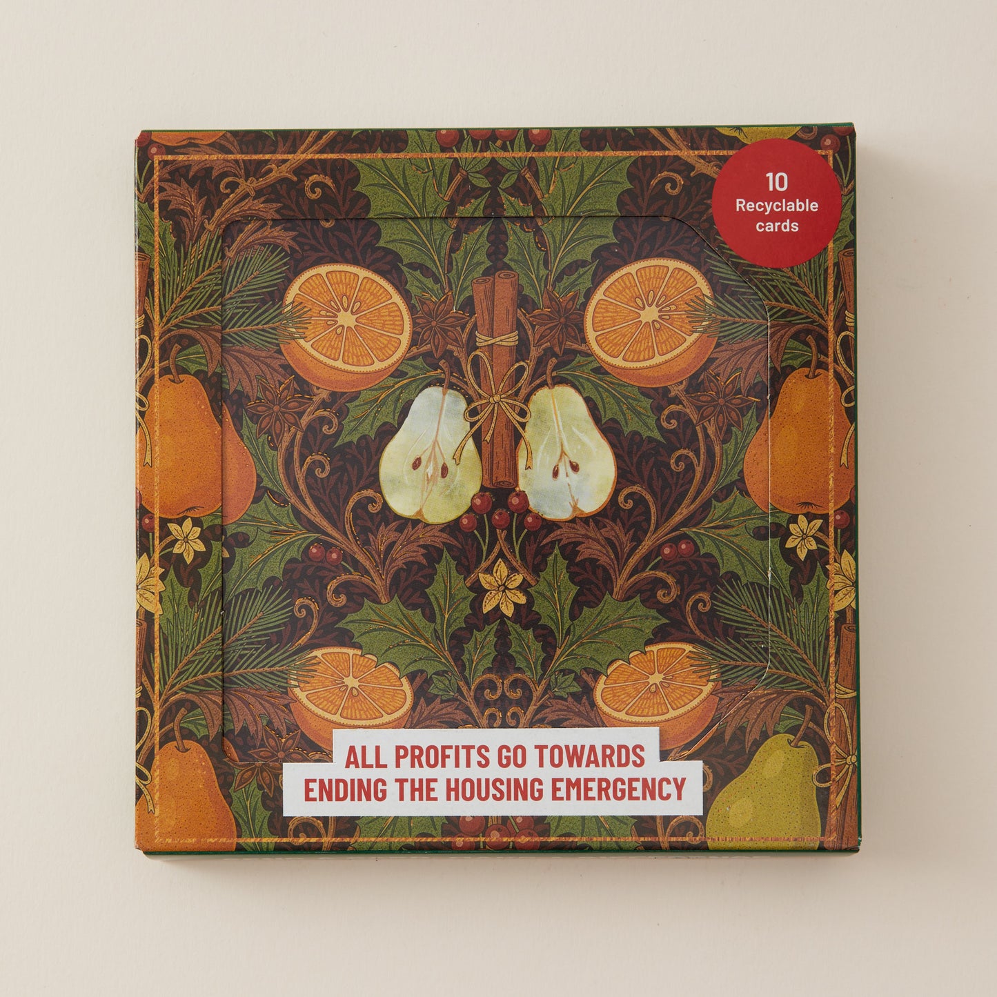 A square product box with a vintage-style botanical and fruit illustration, featuring oranges, pears, and leaves in dark green, brown, and orange tones. A red circular sticker in the top right says '10 Recyclable Cards,' and a white banner at the bottom reads 'ALL PROFITS GO TOWARDS ENDING THE HOUSING EMERGENCY.