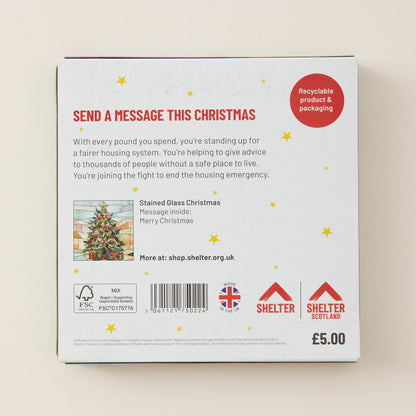 The back of a white product box for a 'Stained Glass Christmas' message kit, featuring red and black text, gold star illustrations, a small stained glass illustration, and Shelter Scotland branding.