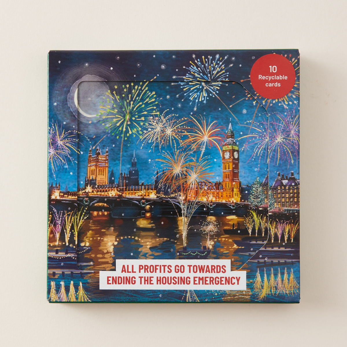 A square product box for a card set featuring an illustrated London night scene with fireworks, Big Ben, the Thames, and a red circular badge that reads '10 Recyclable cards.' Text on the box says 'ALL PROFITS GO TOWARDS ENDING THE HOUSING EMERGENCY.