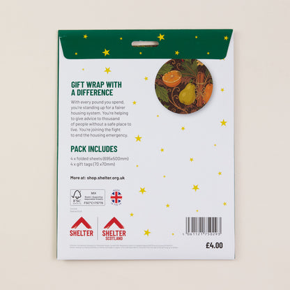 Back of a Shelter gift wrap packaging card on a light beige background. The card is white with a dark green header, yellow star graphics, product text, a circular illustration of wrapped presents, Shelter logos, a barcode, and the price £4.