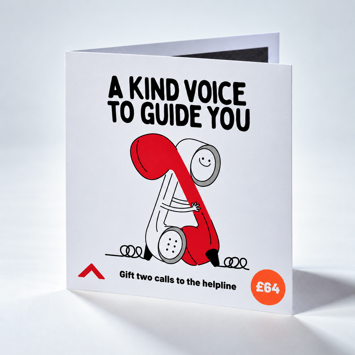 A square greeting card standing upright on a light gray studio background. The card has a white base with bold black text reading 'A KIND VOICE TO GUIDE YOU,' a stylized illustration of a red and white helpline figure, and an orange circle that says '£64.