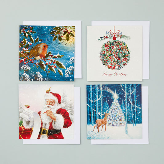 Four square Christmas cards in different designs - one with a reindeer and tree, one with a bauble design, one with a Santa design and one with a robin. Photographed with envelopes.