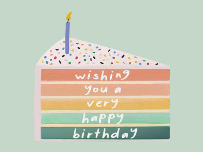 Colorful birthday cake card with a candle on a light green background