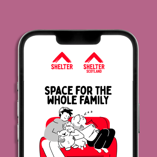 A smartphone mockup displaying the Shelter and Shelter Scotland logos and an eCard on screen. The eCard has text 'SPACE FOR THE WHOLE FAMILY', and a cartoon illustration of a family and dog cuddling on a red sofa.