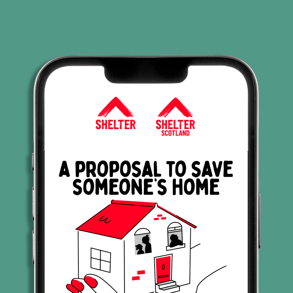 A smartphone mockup displaying a Shelter and Shelter Scotland logo and an eCard design. The eCard has text 'A PROPOSAL TO SAVE SOMEONE'S HOME' and an illustration of a hand holding a house, set against a teal background.