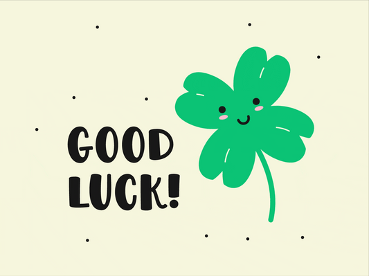 A winking, smiling clover leaf with stars around it and text: 'Good Luck!'