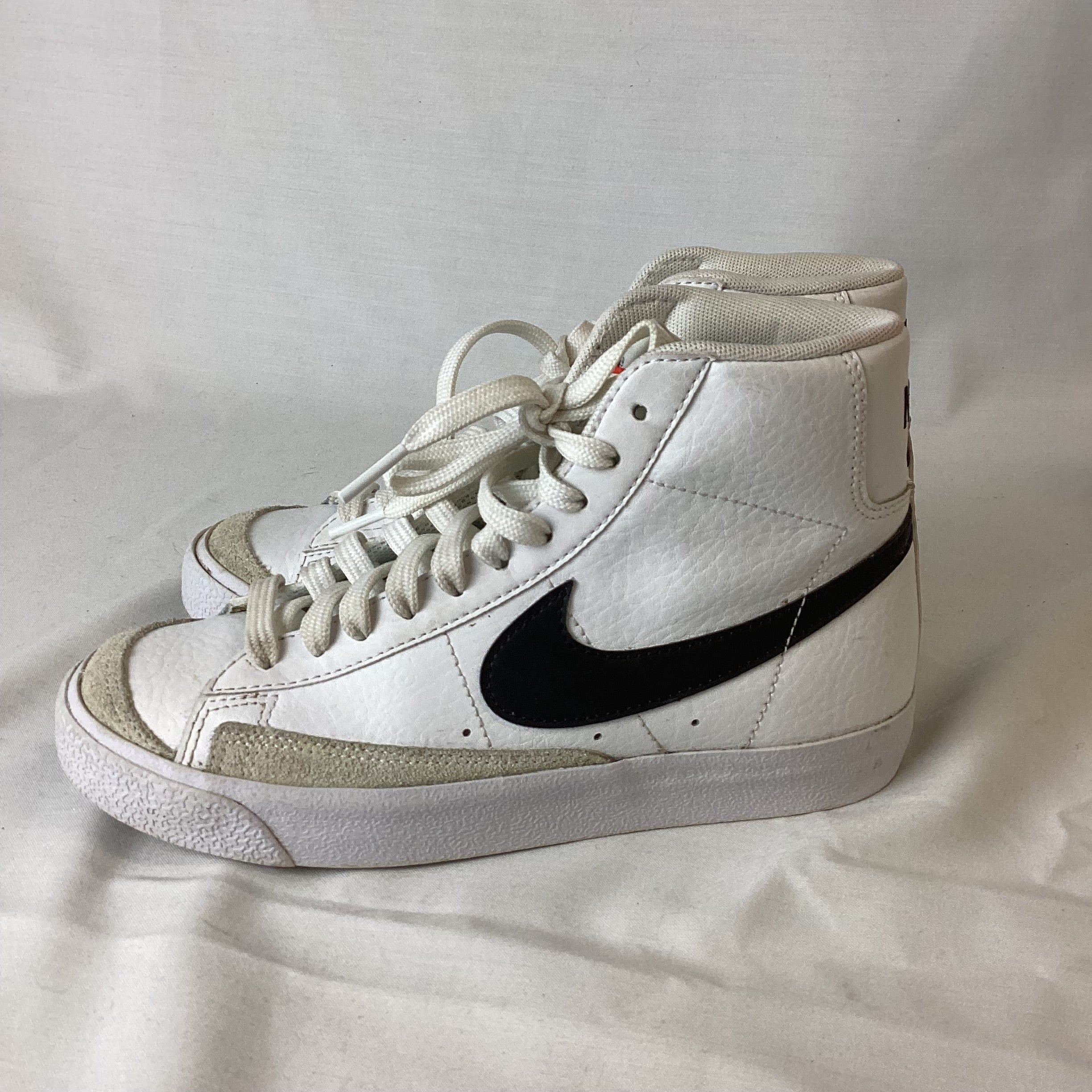 white nike high tops with black swoosh
