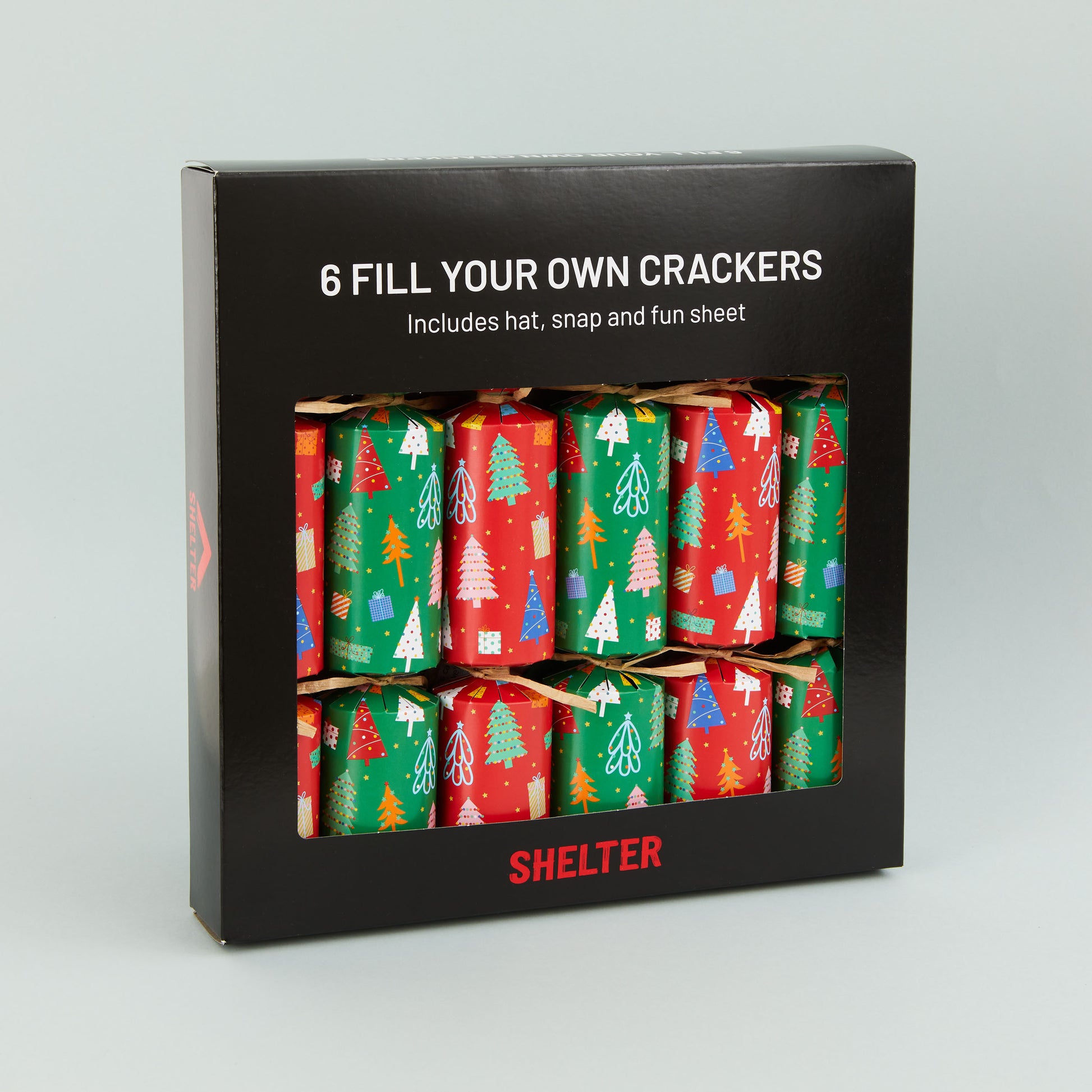 A box of 6 Christmas crackers with red and green Christmas tree design in a card Shelter branded box.